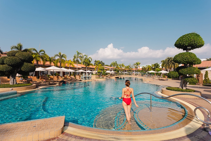 Model enjoying the large swimming pool at Thai Garden Resort