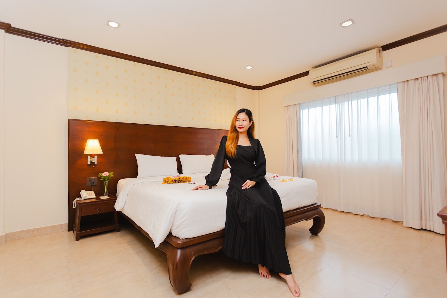 Woman enjoying a calm moment on the bed at Thai Garden Resort Pattaya