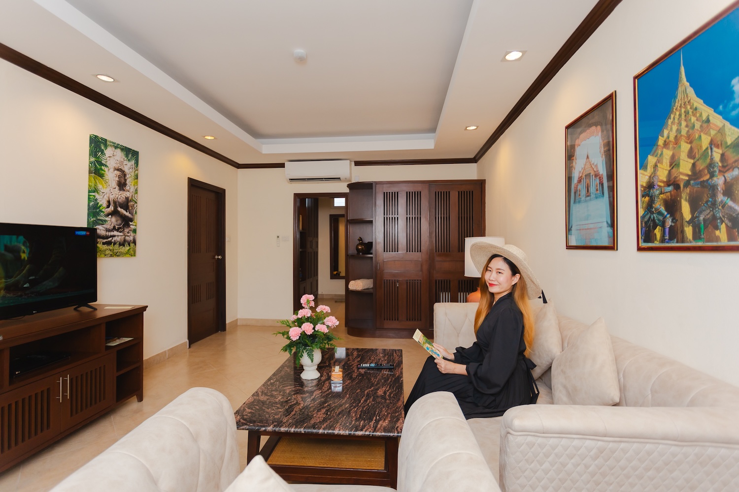 Woman relaxing in the serene living room at Thai Garden Resort Pattaya