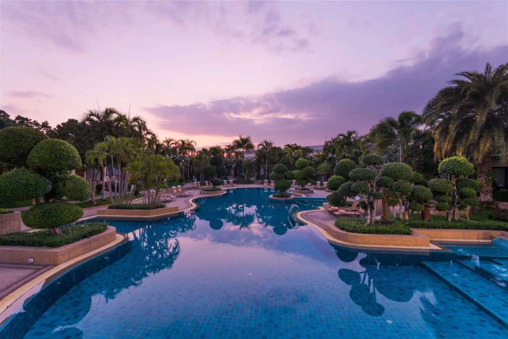 Swimming pool at Thai Garden Resort in Pattaya during a vibrant sunset