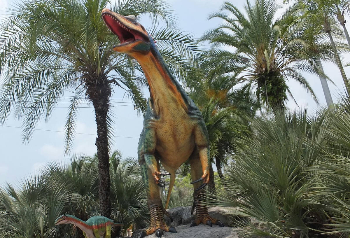 Life-size dinosaur statues at Nong Nooch Tropical Garden in Pattaya, a favorite attraction for families and kids.
